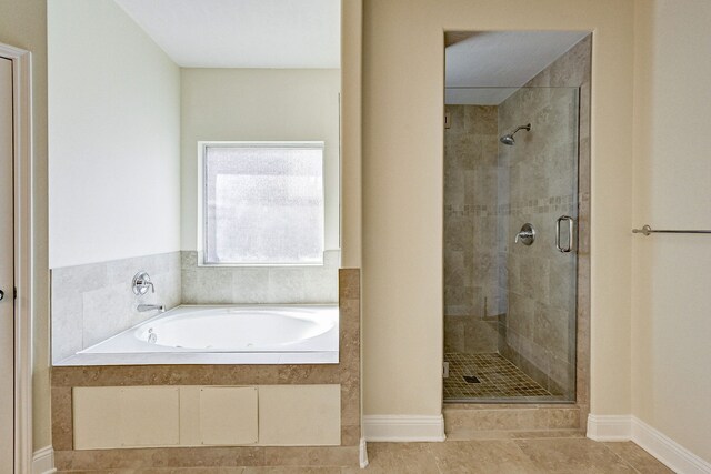 bathroom featuring tile patterned floors and independent shower and bath