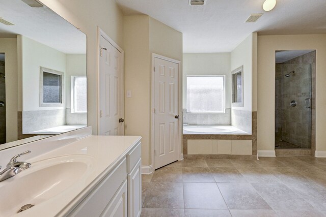 bathroom featuring vanity, separate shower and tub, and tile patterned flooring