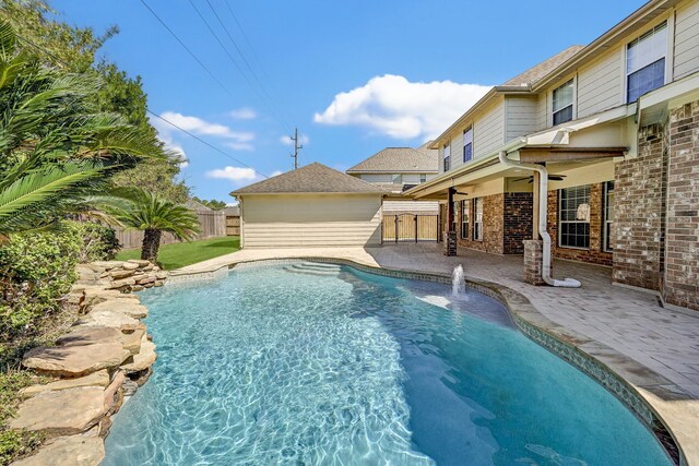 view of swimming pool featuring pool water feature and a patio area