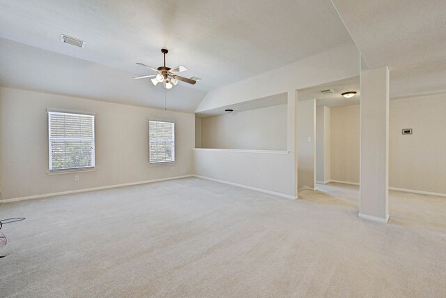 spare room featuring ceiling fan, vaulted ceiling, and light colored carpet