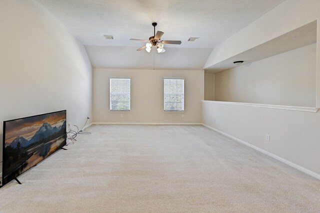 unfurnished living room featuring vaulted ceiling, light colored carpet, and ceiling fan