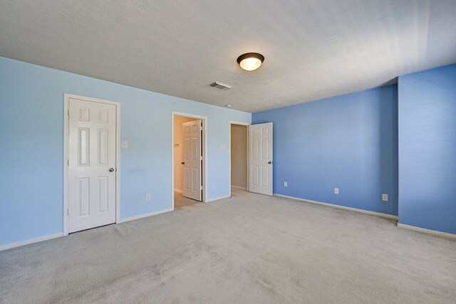 unfurnished bedroom with light colored carpet