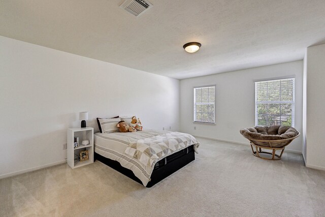 carpeted bedroom featuring a textured ceiling