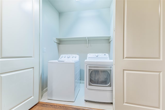 laundry area featuring washer and dryer and light wood-type flooring