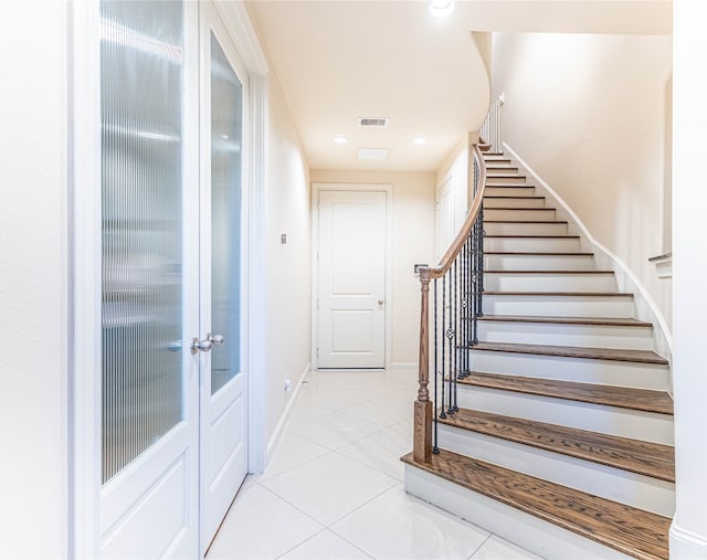 stairs featuring tile patterned flooring