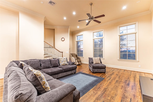 living room with ceiling fan, wood-type flooring, and ornamental molding