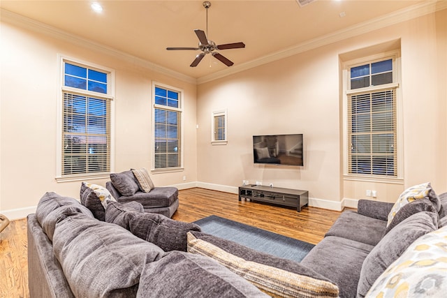 living room featuring hardwood / wood-style floors, ceiling fan, and ornamental molding