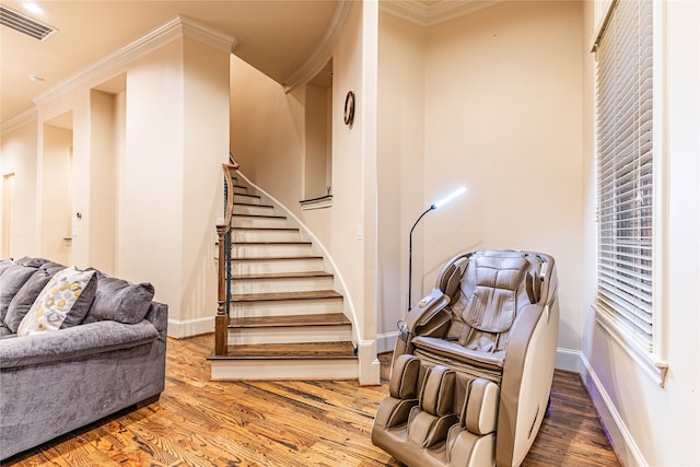 stairway featuring crown molding and hardwood / wood-style floors