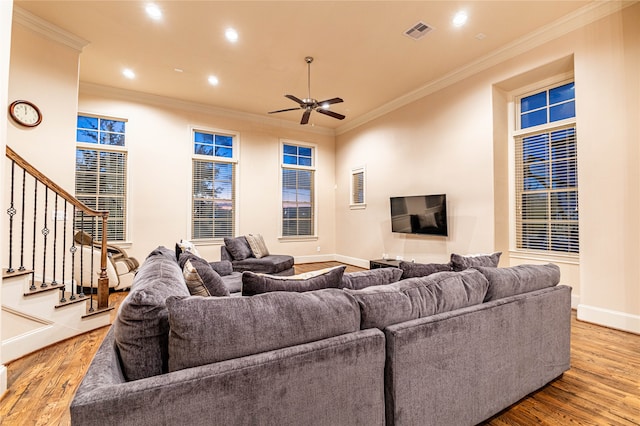 living room with crown molding, ceiling fan, and light hardwood / wood-style floors