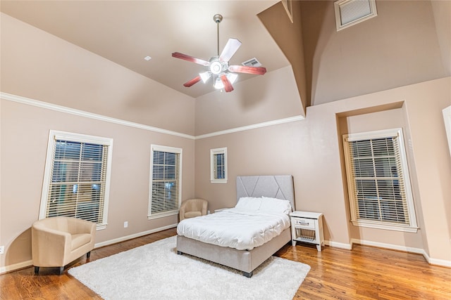 bedroom featuring ceiling fan, high vaulted ceiling, and hardwood / wood-style flooring