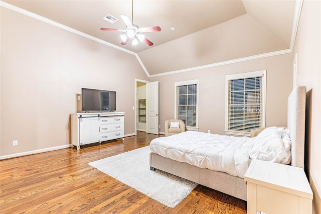 bedroom with wood-type flooring, crown molding, ceiling fan, and lofted ceiling