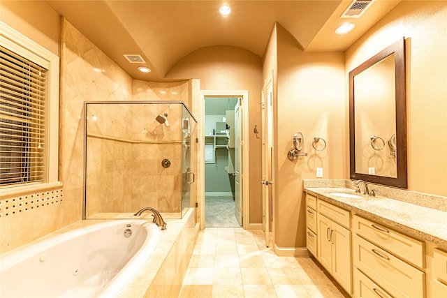 bathroom featuring tile patterned flooring, vanity, and shower with separate bathtub