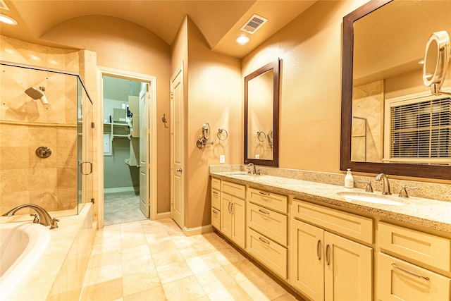 bathroom with tile patterned floors, vanity, and shower with separate bathtub