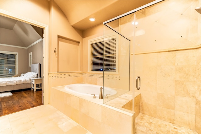 bathroom with hardwood / wood-style flooring, lofted ceiling, ornamental molding, and plus walk in shower