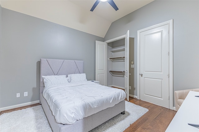 bedroom featuring hardwood / wood-style flooring, ceiling fan, and vaulted ceiling