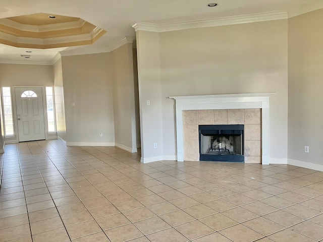 unfurnished living room featuring a fireplace, crown molding, and light tile patterned floors