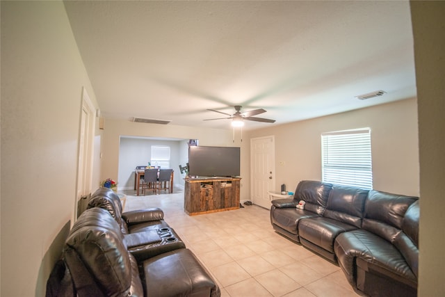 tiled living room featuring ceiling fan