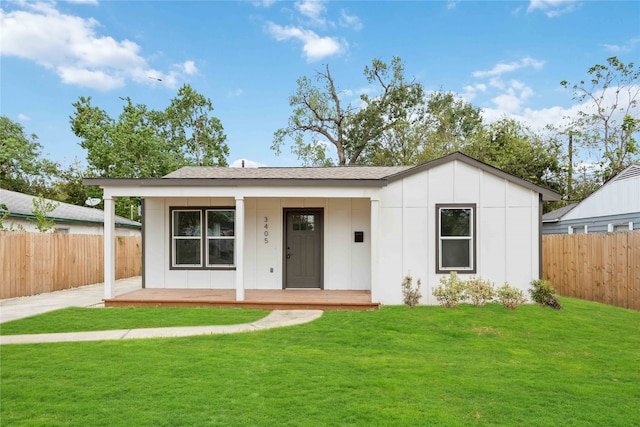 ranch-style house with a porch and a front lawn