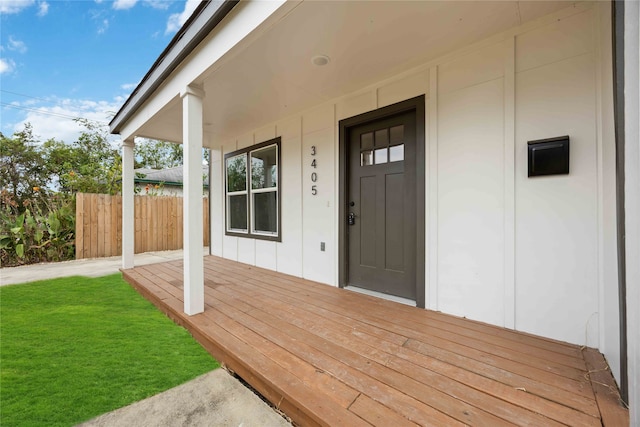 property entrance with a lawn