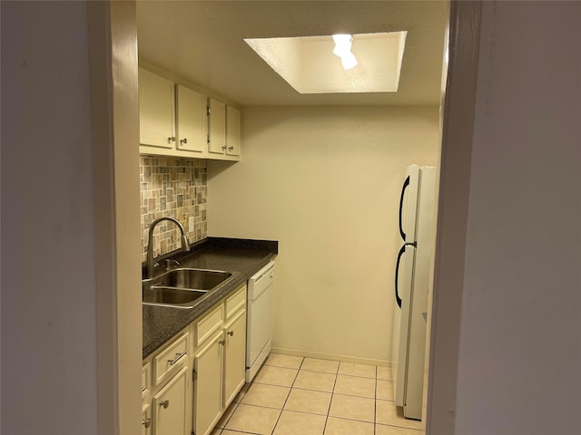 kitchen with white cabinets, tasteful backsplash, white appliances, sink, and light tile patterned floors