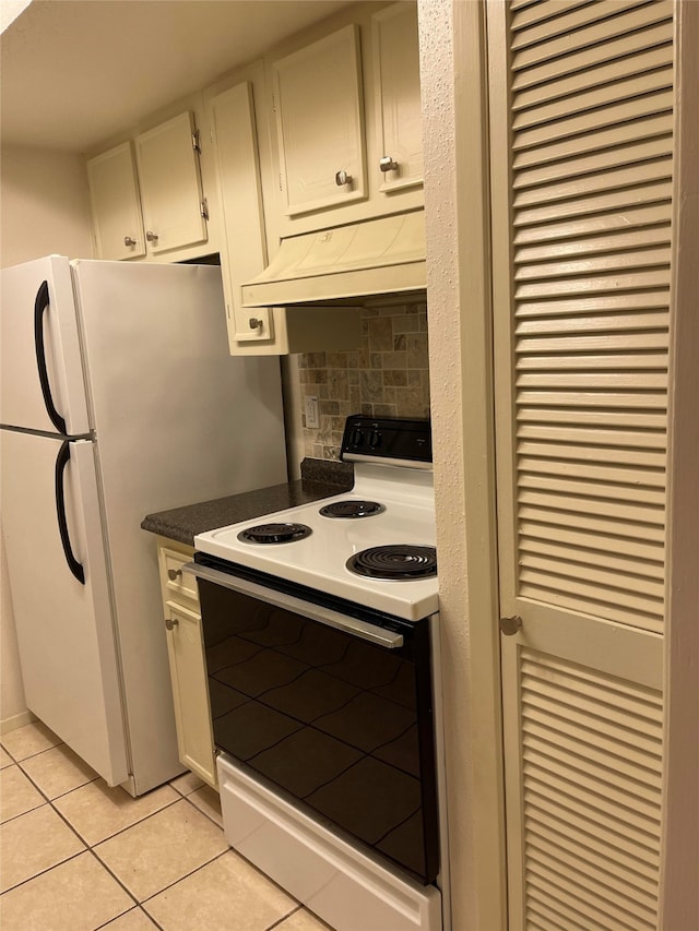 kitchen featuring white cabinetry, white electric stove, light tile patterned floors, and tasteful backsplash