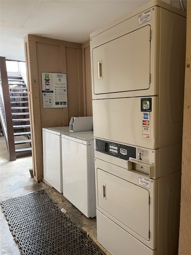 clothes washing area featuring stacked washer and dryer