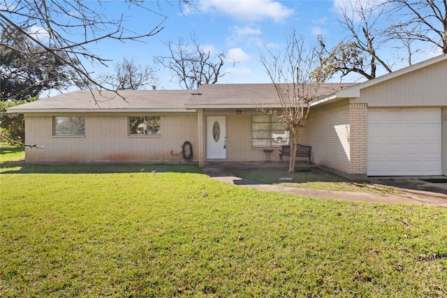 ranch-style home with a garage and a front lawn