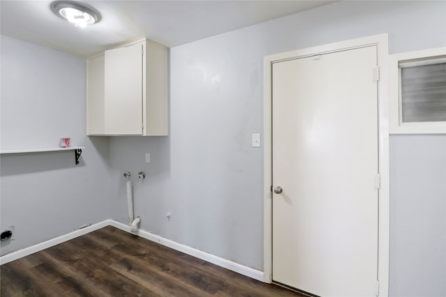 washroom with dark hardwood / wood-style floors, cabinets, and hookup for a washing machine