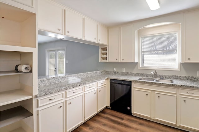 kitchen featuring sink, light stone countertops, black dishwasher, dark hardwood / wood-style flooring, and white cabinetry