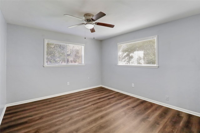 empty room with ceiling fan and dark wood-type flooring