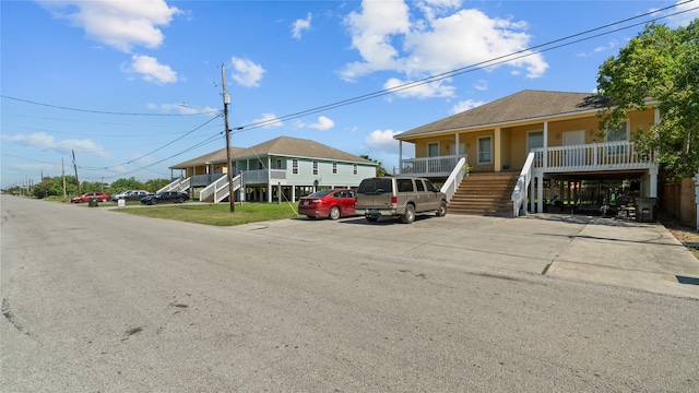 view of front of property with covered porch and a carport