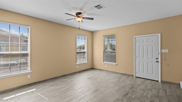 503 12th St, San Leon, TX 77539 - spare room featuring ceiling fan, light wood-style floors, and healthy amount of natural light