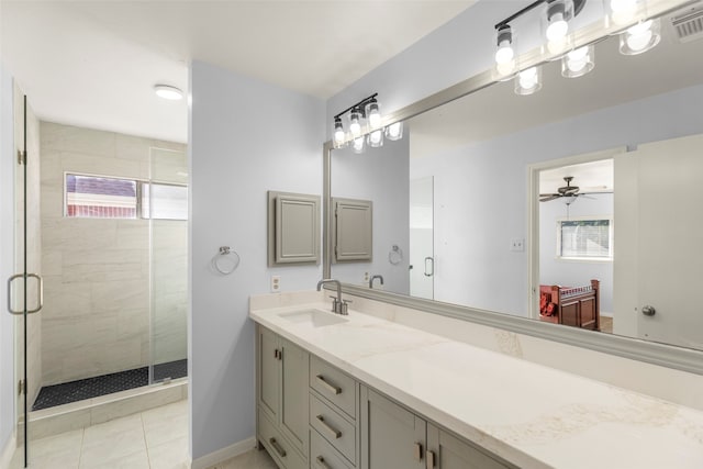 bathroom with tile patterned floors, vanity, ceiling fan, and an enclosed shower