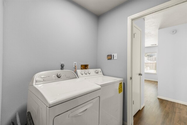 laundry room with dark hardwood / wood-style floors and washing machine and clothes dryer