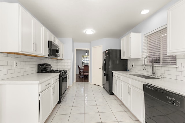 kitchen with white cabinetry, sink, decorative backsplash, light tile patterned flooring, and black appliances