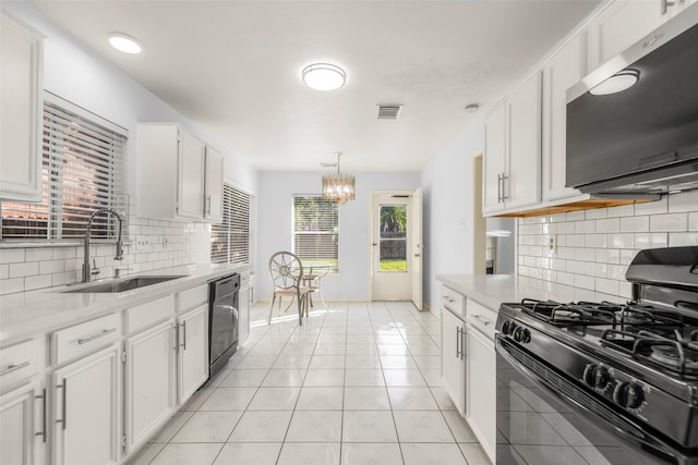 kitchen featuring black appliances, sink, decorative backsplash, light tile patterned floors, and white cabinetry