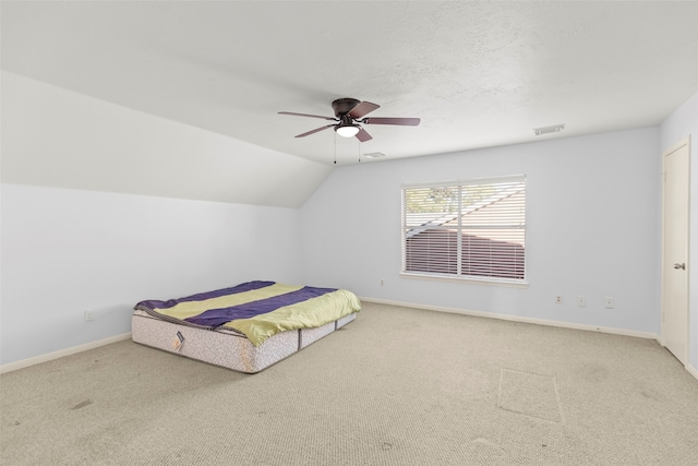 unfurnished bedroom featuring carpet, ceiling fan, and lofted ceiling