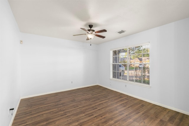 empty room with dark wood-type flooring and ceiling fan