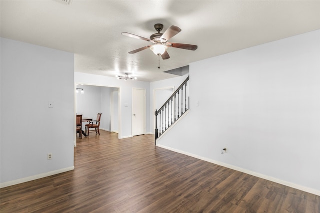 unfurnished room with ceiling fan and dark wood-type flooring