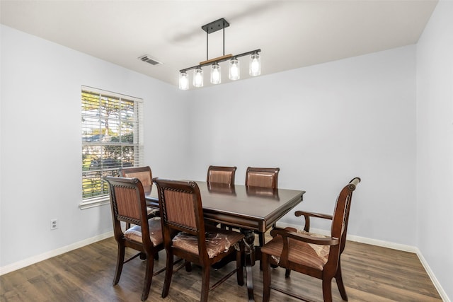 dining space with dark hardwood / wood-style floors