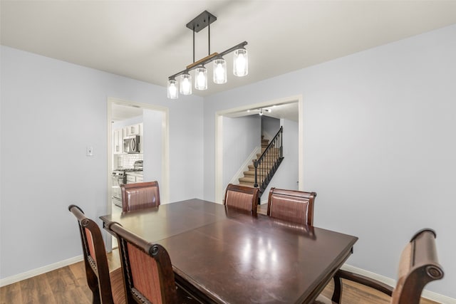 dining space with hardwood / wood-style flooring