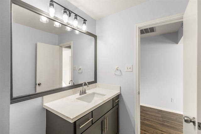 bathroom with vanity and hardwood / wood-style flooring