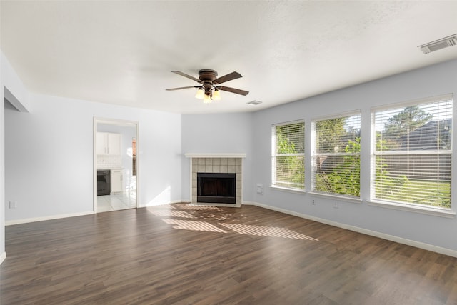 unfurnished living room with ceiling fan, a fireplace, and hardwood / wood-style flooring