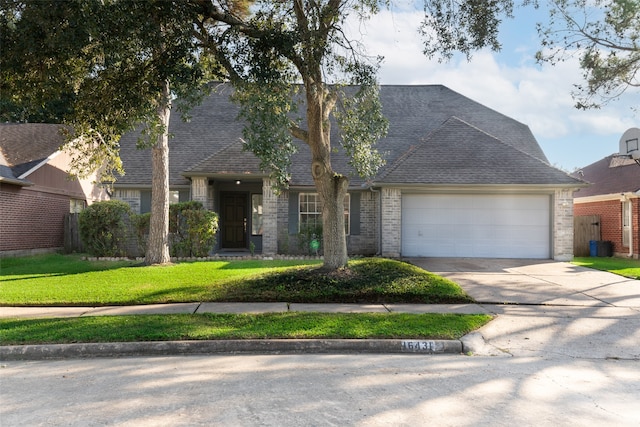 view of front of property with a garage and a front yard