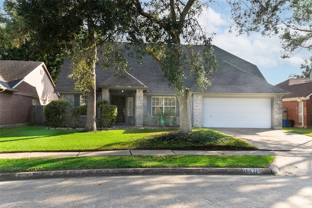 view of front facade with a front yard and a garage