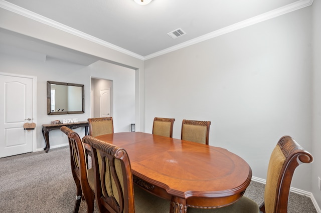 dining space with ornamental molding and carpet flooring