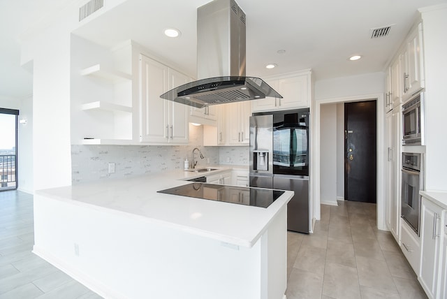 kitchen with stainless steel appliances, tasteful backsplash, white cabinets, kitchen peninsula, and island exhaust hood