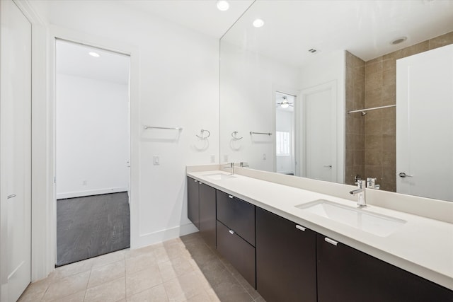 bathroom featuring vanity, a tile shower, and hardwood / wood-style flooring