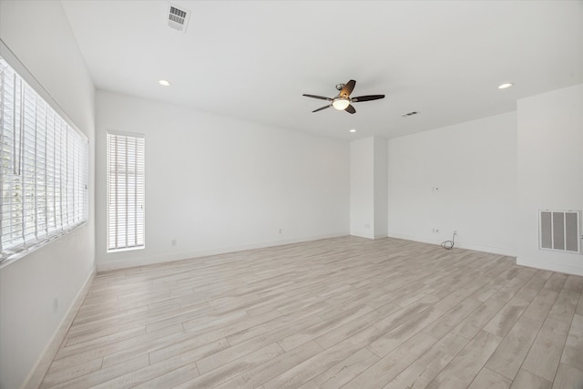 spare room with ceiling fan and light wood-type flooring