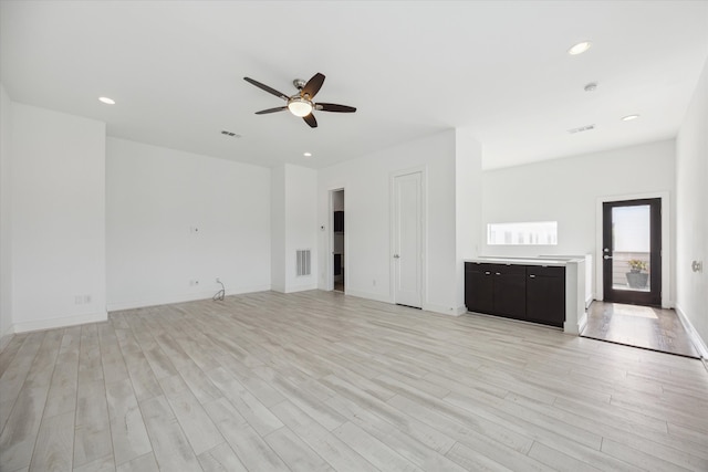 unfurnished living room with light hardwood / wood-style flooring and ceiling fan